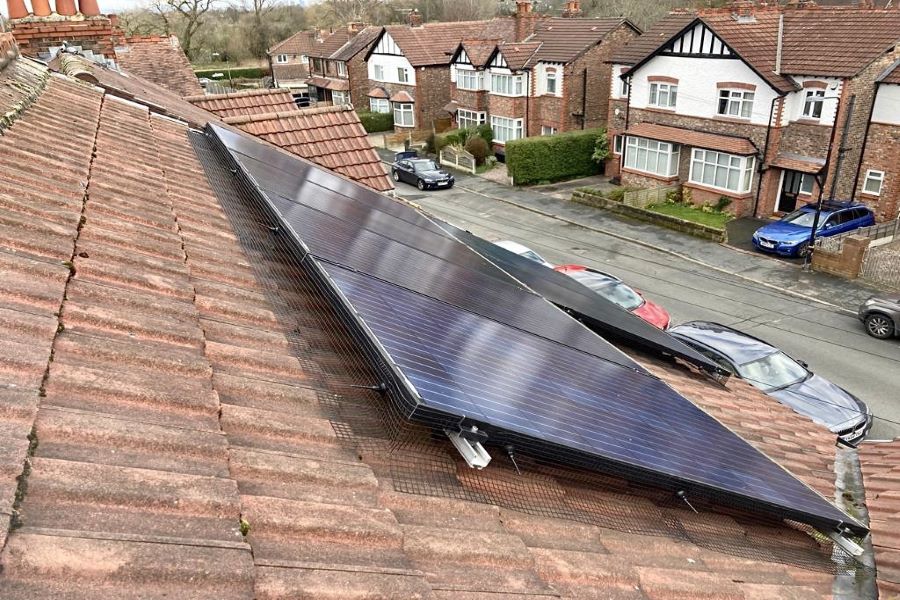 Solar panel protection. Black PVC coated galvanised mesh wrapped around solar panels on a roof to offer proofing to bird and other pests.